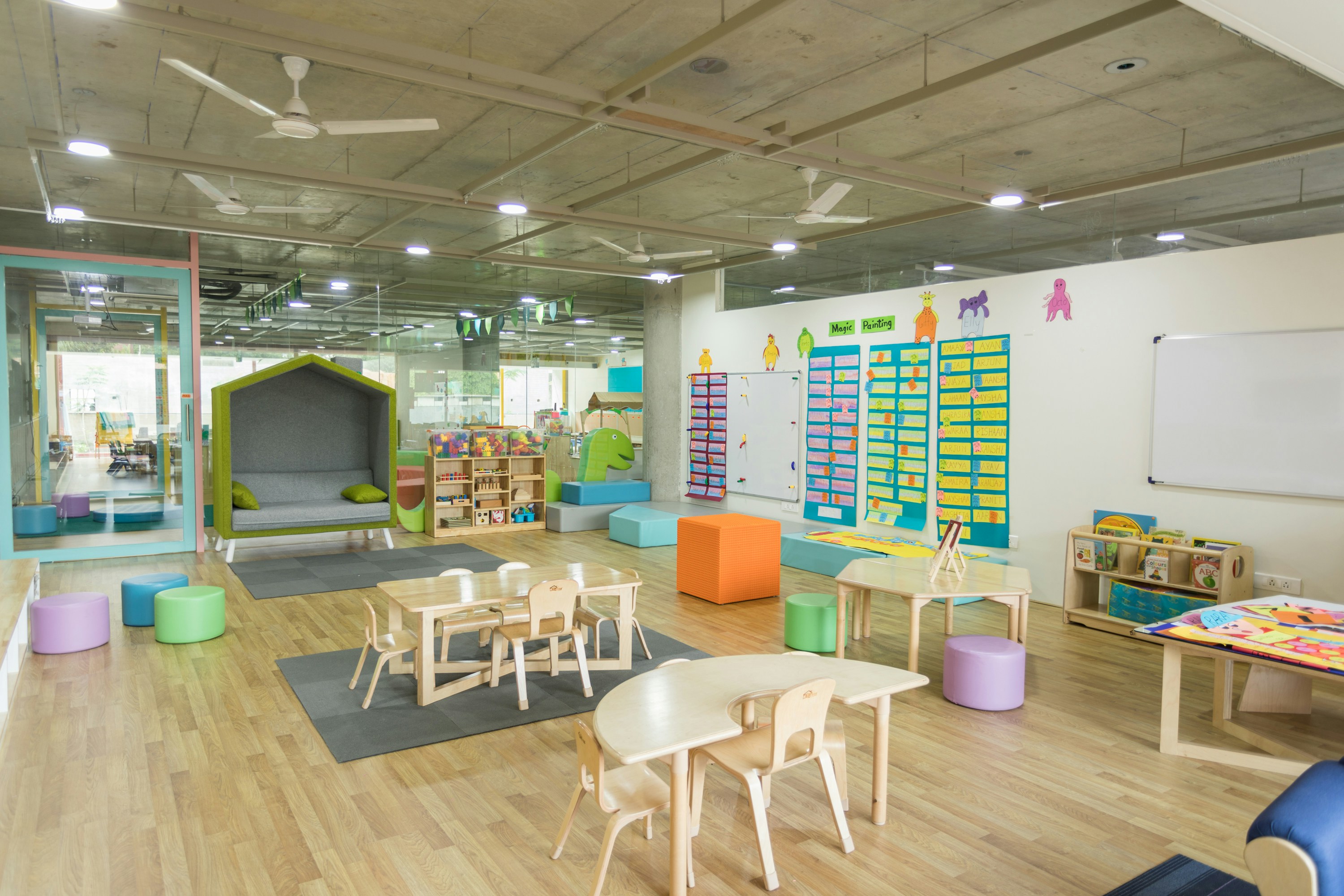 A classroom with both structured learning materials on shelves and open-ended, natural play items.