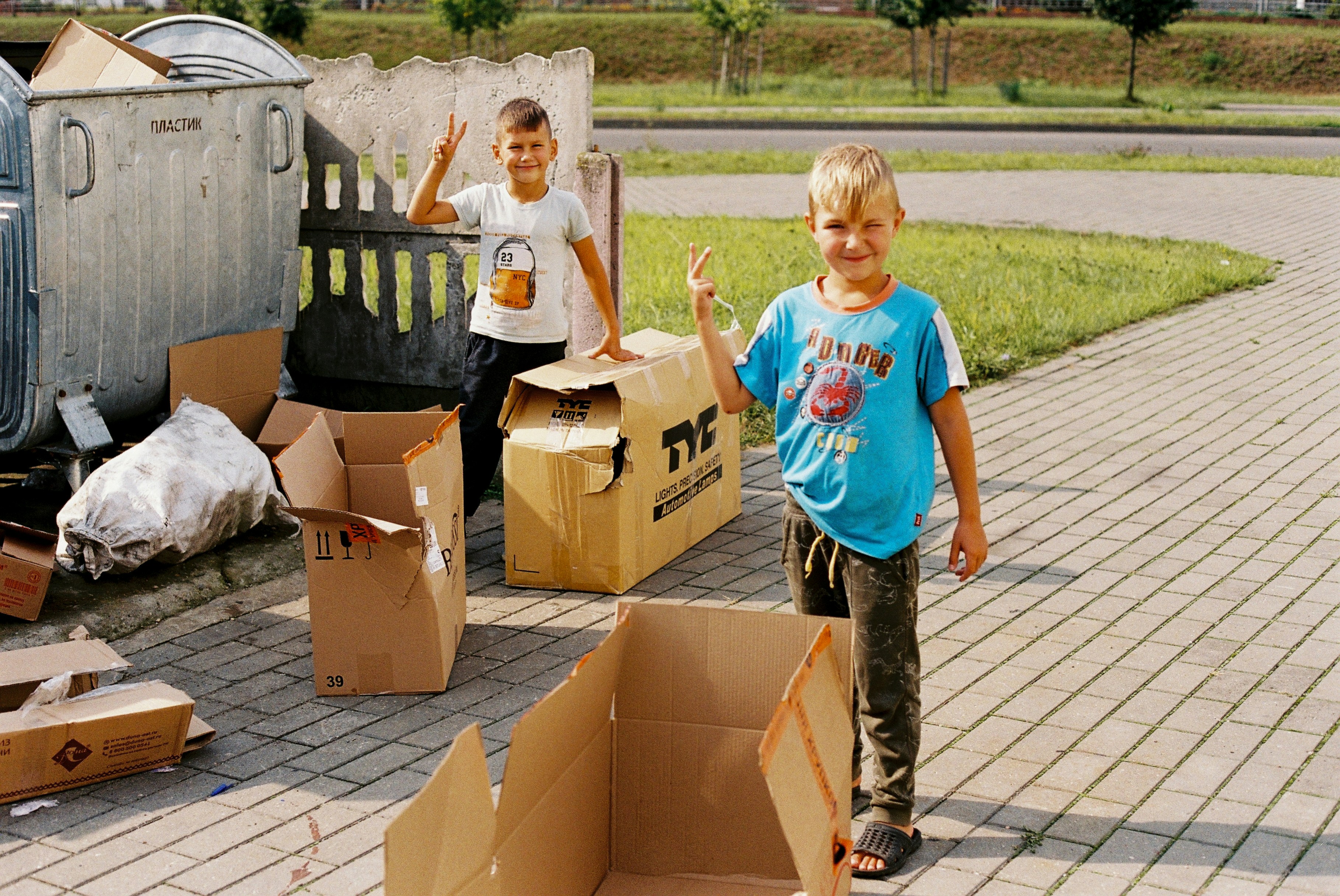 A child carefully placing toys back into a wooden box, showing responsibility.